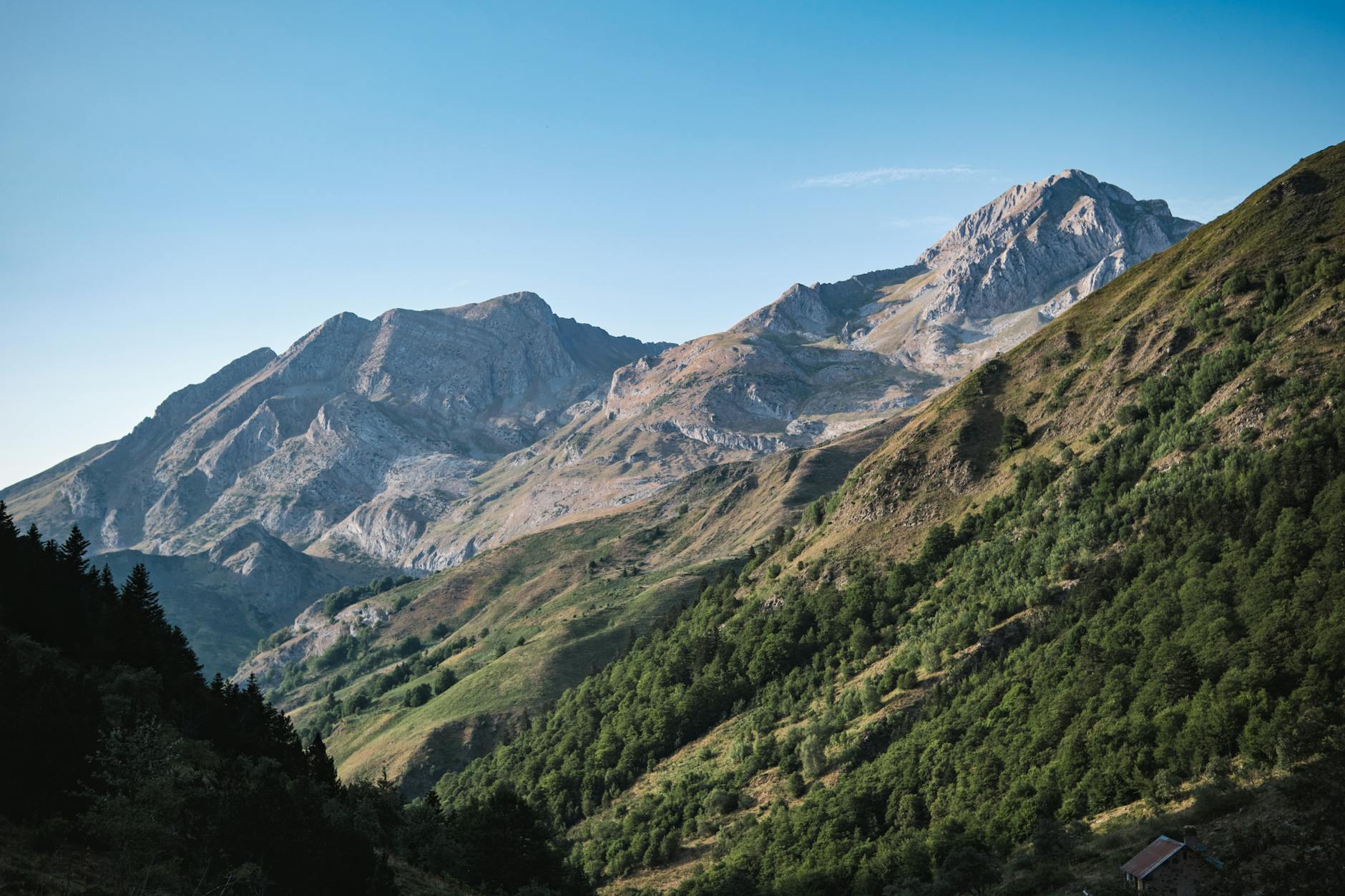 Panorama des Pyrénées en Occitanie avec sentier de randonnée en crête sous un ciel dégagé