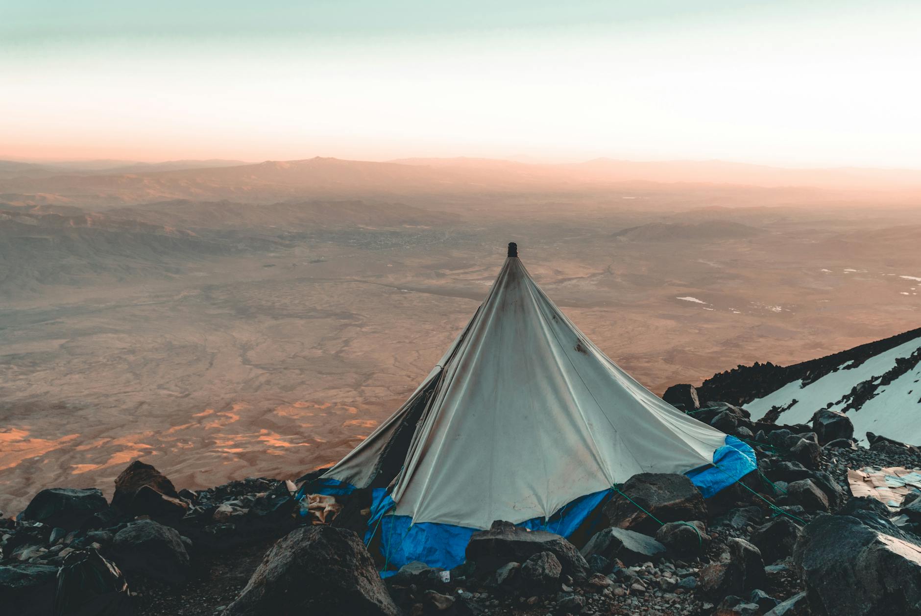 Tente et sac de couchage au petit matin dans un bivouac de montagne par temps froid